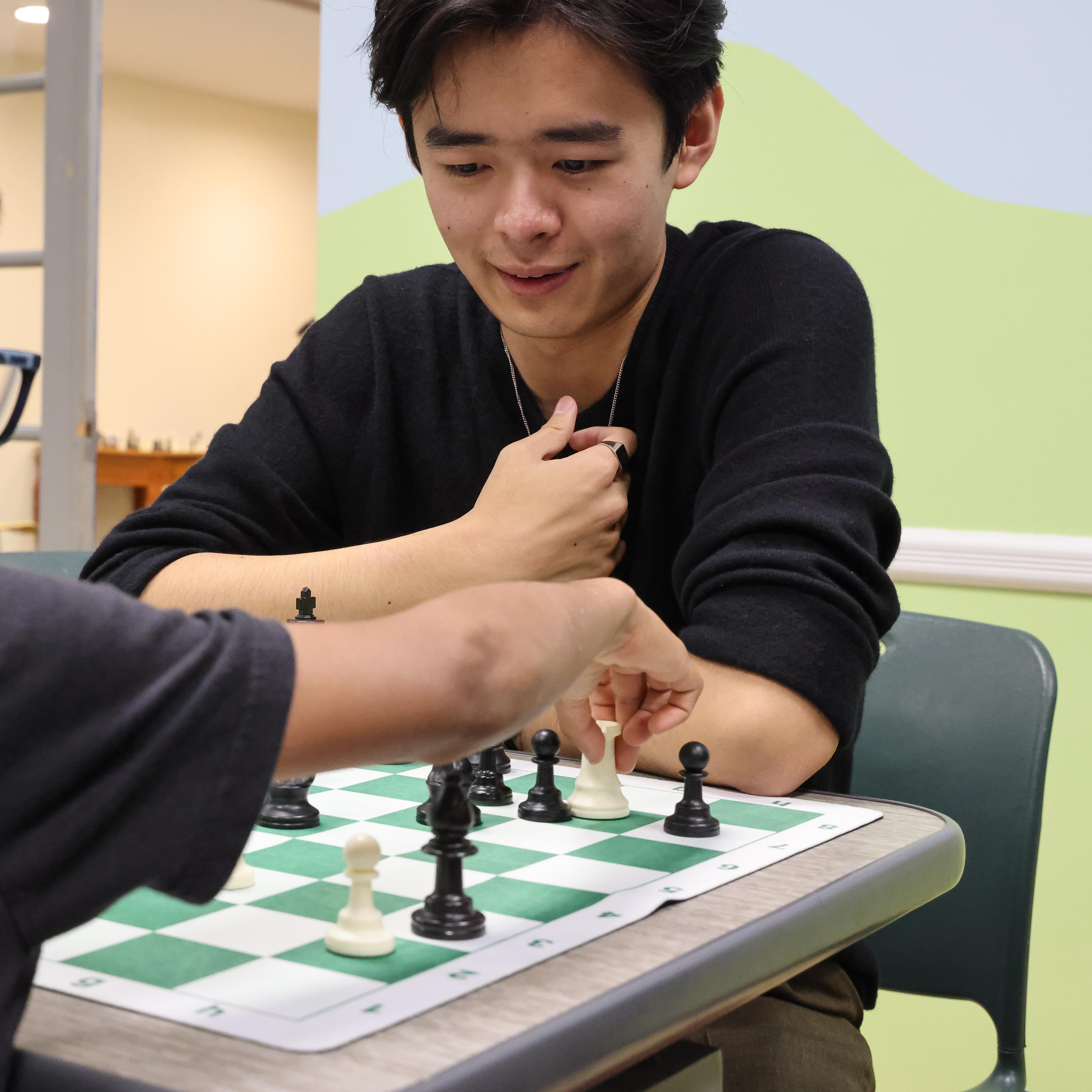 Samuel Zhang playing against a club player